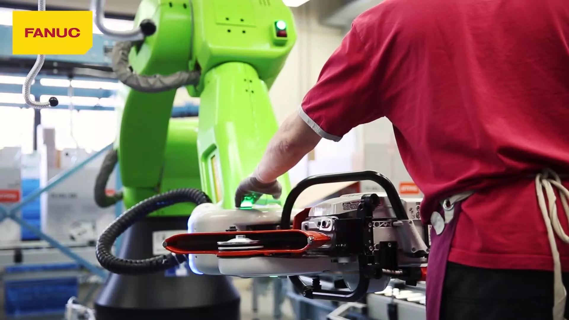 Worker safely collaborating with a Fanuc collaborative robot in manufacturing facility